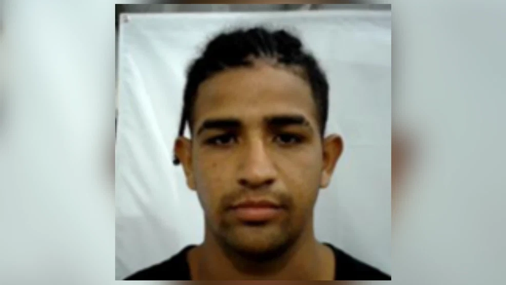 Julio Cesar Sosa-Celis in a black crew-neck shirt, photographed in a head-and-shoulders portrait