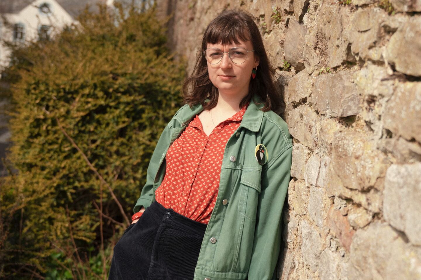 Rebecca Burke photographed near her parents' home in south Wales, wearing a red patterned shirt and olive green jacket